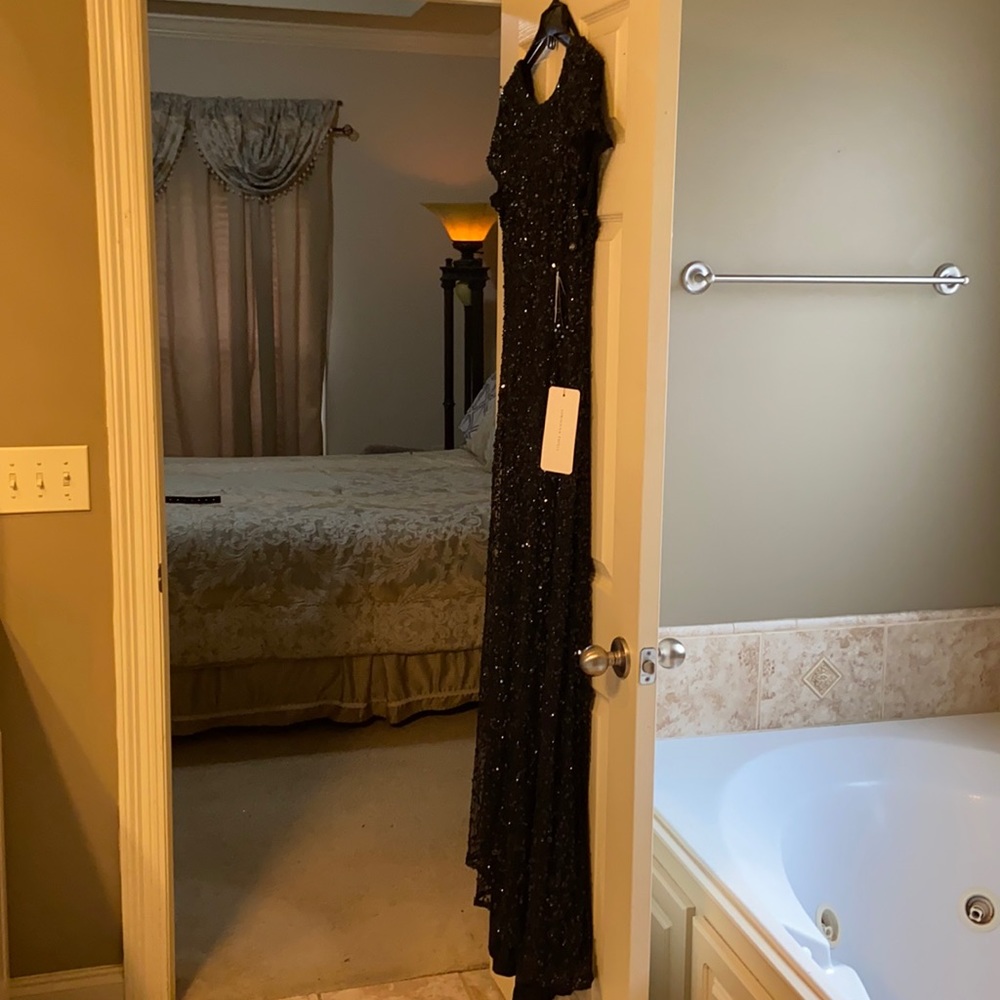 Long black evening gown with scoop neck.